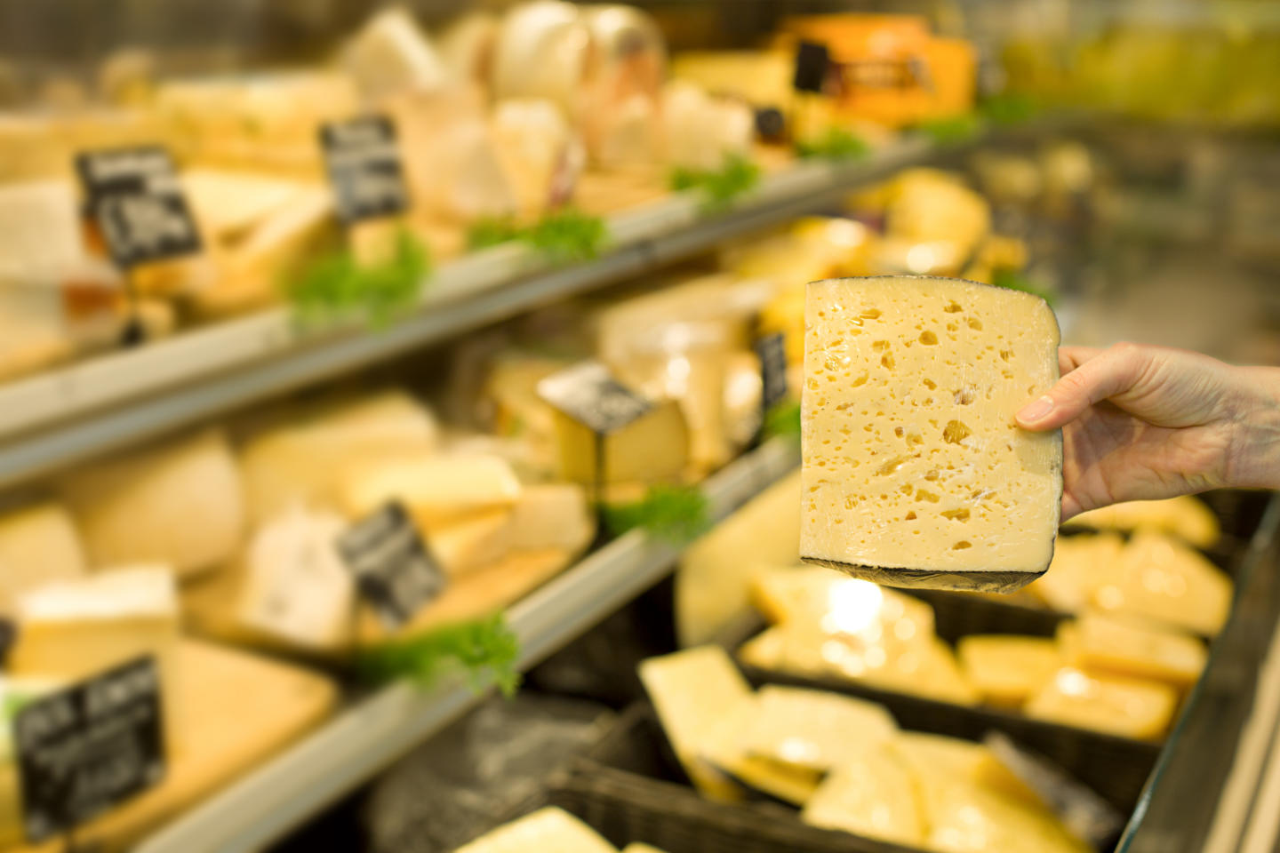 Woman'S Hand Choosing Cheese In Supermarket. Concept Of Healthy